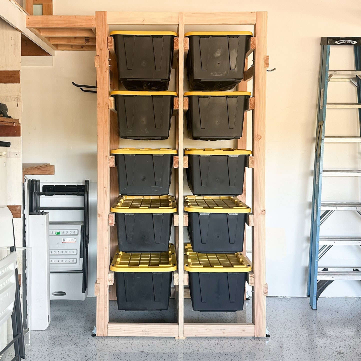 Wooden storage rack with plastic bins in a garage setting